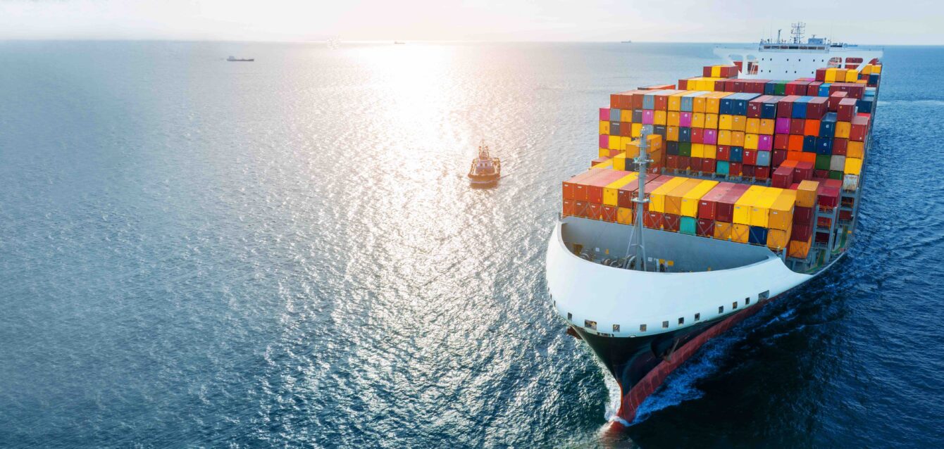 Side of cargo ship carrying container and running for export goods from cargo yard port to custom ocean concept technology transportation , customs clearance. Freight Forwarding Service