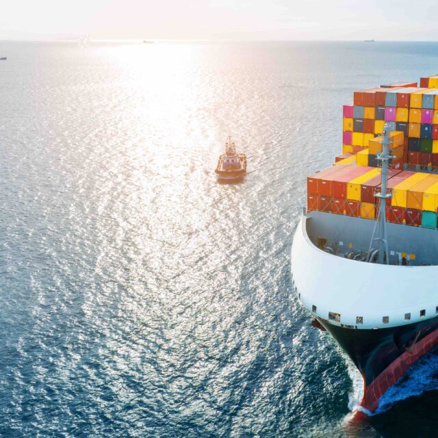 Side of cargo ship carrying container and running for export goods from cargo yard port to custom ocean concept technology transportation , customs clearance. Freight Forwarding Service